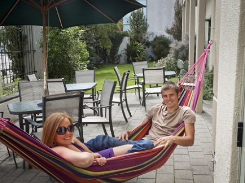 Nelson Backpackers Courtyard Relaxing in a hammock at Central Nelson Backpackers and Hostel