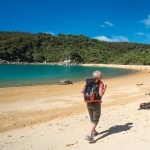 Lady Hiking along the beach in The Abel Tasman National park